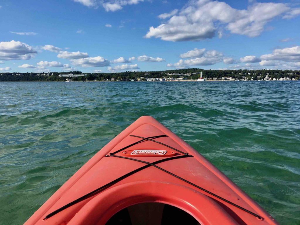 Kayaking on Lake Huron with the Mackinac Island in the distance.