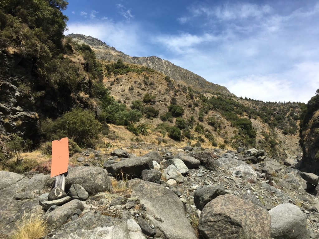 Orange sign indicated the trail leaves the riverbed and heads up the hillside