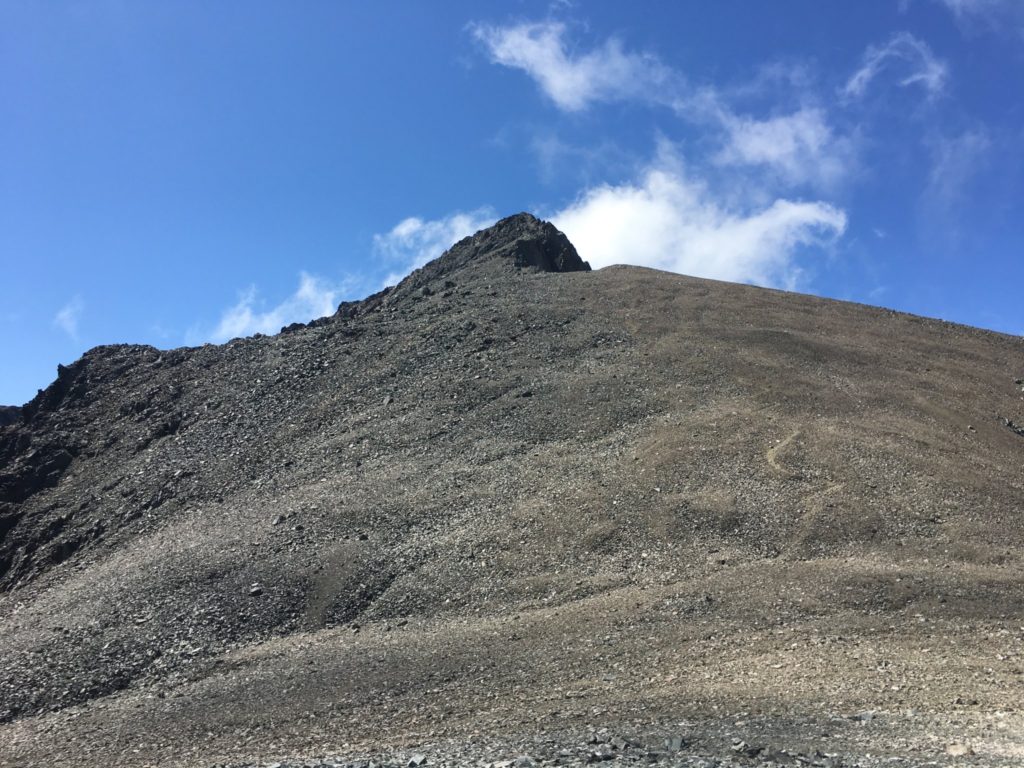 The trail switchbacks up the rock scree before the final ridge to the summit